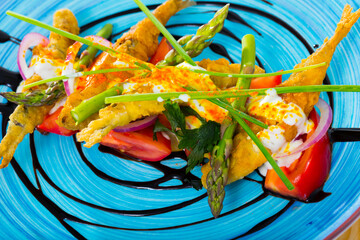 Wall Mural - Deliciously fried sardines in batter and creamy-ginger sauce on cushion of sweet tomatoes and balsamic paste