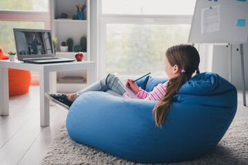 Poster - Full body photo of cute small schoolgirl home education sit bean bag writing lecture school interior