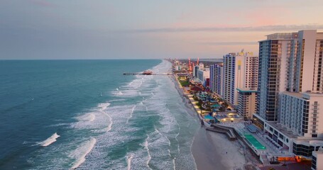 Wall Mural - Daytona Beach, Florida. Tourist attractions and infrastructure at sunset. Illuminated luxurious hotels and apartment buildings in southern Florida, USA.