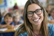 © EarthWalker - Beautiful female teacher in glasses smiling and looking into camera at elementary school with children at the blurred background