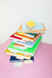 © Colour Laboratory/Stocksy - Tower of colorful books in a office business desk with hard flashlight