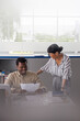 © Jovo Jovanovic/Stocksy - Happy entrepreneurs discussing over document in office