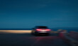 © Ibai Acevedo/Stocksy - Blurred car in movement at sunset