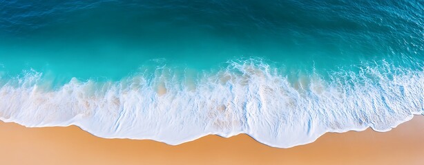 Wall Mural - aerial view of a beach with turquoise waters, waves gently lapping, nature background with copy spac