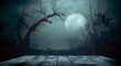 © Daniel - Old wood table and silhouette dead tree at night for Halloween background.
