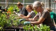 © Junior - A group of adults taking a gardening class, planting seeds and tending to plants in a greenhouse, with the instructor demonstrating proper techniques