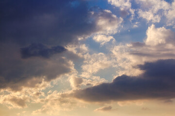 Canvas Print - dramatic dusk. dynamic clouds on the sky in golden light above the horizon. summer holidays rainy weather forecast