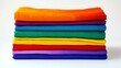 © VISUAL BACKGROUND - A stack of brightly colored shirts on a white surface