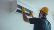 © sup - HVAC Technician Examining AC Unit