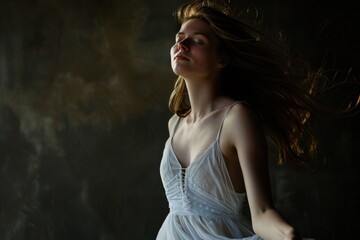 Poster - A woman wearing a white dress with her hair blown by the wind, suitable for use in fashion or lifestyle images