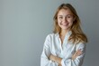 © julija - radiant businesswoman portrait confident young woman with bright smile and crossed arms clean highkey lighting emphasizes positivity and professionalism