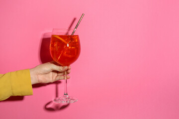 Wall Mural - Woman with glass of refreshing cocktail on pink background, closeup. Space for text