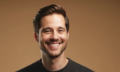 Canvas Print - Portrait of a handsome young man smiling on a beige background