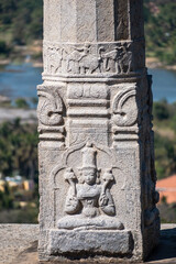 Wall Mural - Beautiful stone carving of a mythological deity on a pillar of an ancient temple in Shravanabelagola.