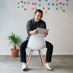 Poster - Asian man, tablet and online for marketing project in office, social media manager and plan agenda. Male person, chair and app for market research or review public feedback, monitor trend and report