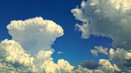 Wall Mural - Low angle timelapse shot of cumulus clouds on blue clear sky. Fluffy white clouds.