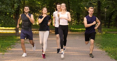 Wall Mural - Young sporty people running outdoors