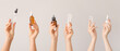 © Pixel-Shot - Female hands with different cosmetic products in bottles on grey background