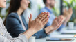 © Verzh - Photos of Business team clapping hands after successful conferance in meeting in modern office