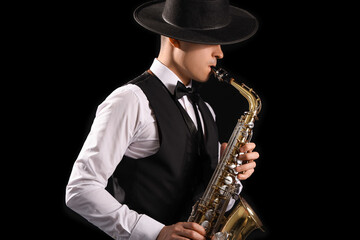 Poster - Male artist playing saxophone on black background