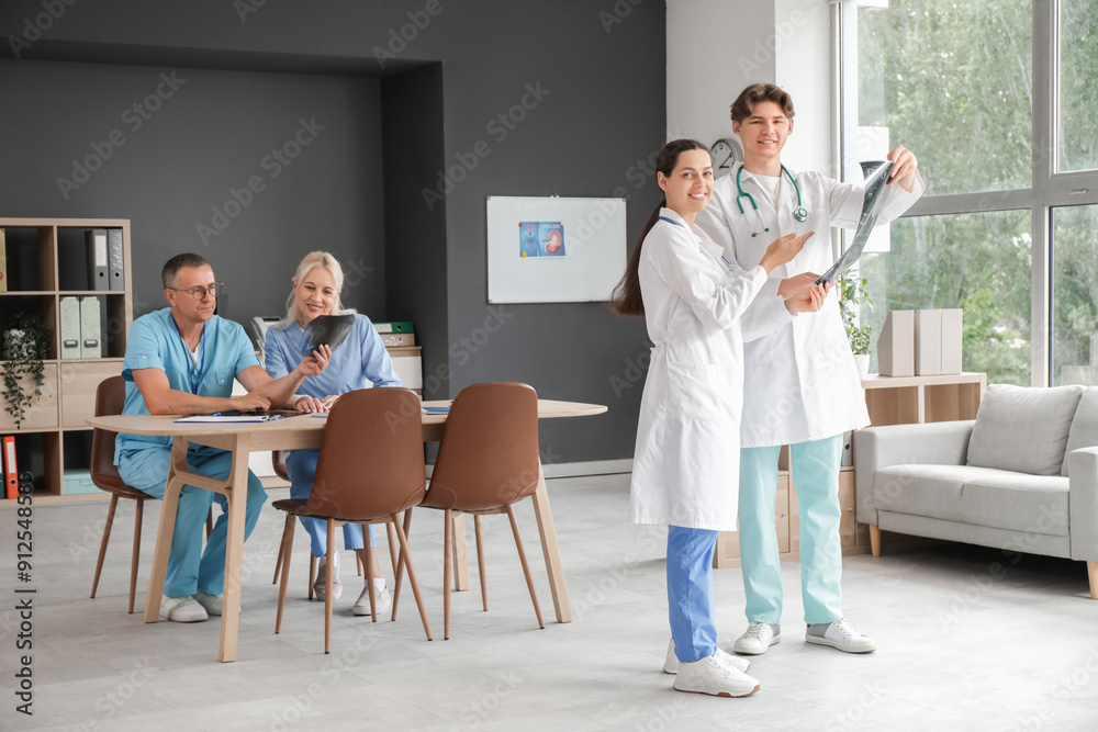Group of doctors studying x-ray images in clinic
