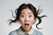 © Elio - Messy haired Asian Girl with funny confused expression, isolated white background