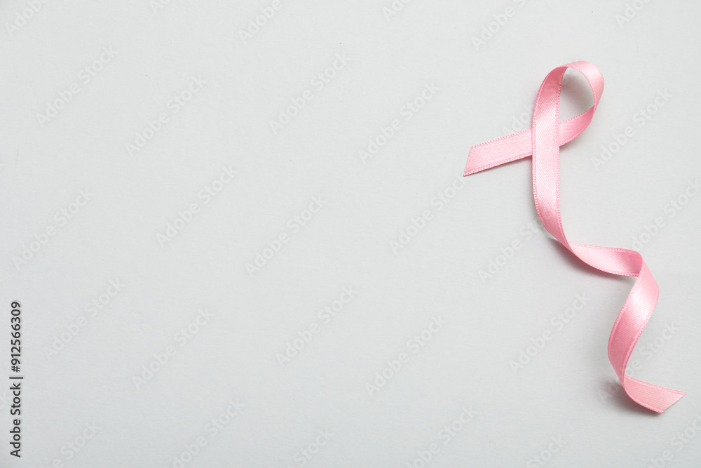 Pink silk ribbon on grey background. Breast cancer concept