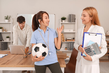 Poster - Female teachers talking in school office