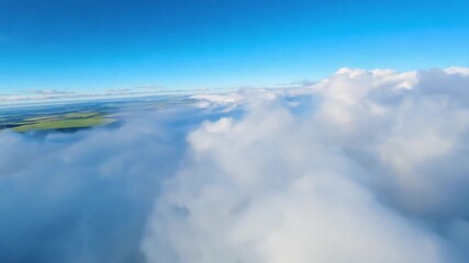 flying above clouds in the sky view on green fields below
