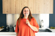 © mdyn - Portrait of excited hungry young woman holding fork in her mouth, biting and dreaming about delicious healthy food at the kitchen. Diet concept