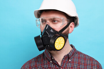 Sticker - Man in respirator mask and hard hat on light blue background