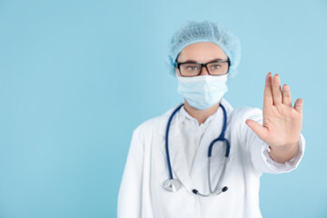 Wall Mural - Doctor touching something on light blue background, selective focus. Space for text