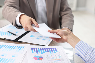 Poster - Boss giving salary in paper envelope to employee indoors, closeup