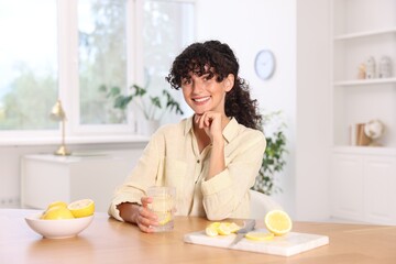 Sticker - Woman with glass of lemon water indoors