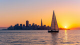 A sailboat in front of the San Francisco skyline, viewed from Sausalito at sunset.