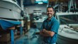 © VK Studio - A smiling man in a boat workshop, surrounded by various boats and equipment, radiating pride and dedication to his craft.