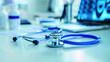 © khonkangrua - Close-up of a blue stethoscope lying on a white desk in a medical office, representing healthcare and diagnostics.