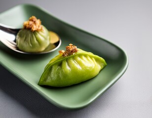 Wall Mural - A green squash and pork dumpling with roasted garlic, served in a spoon on a grey background, representing traditional Hong Kong cuisine.