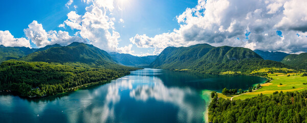 Wall Mural - Aerial view of Bohinj lake in Julian Alps. Popular touristic destination in Slovenia. Bohinj Lake, Church of St John the Baptist. Triglav National Park, Julian Alps, Slovenia.