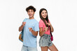 © InsideCreativeHouse - Positive two diversity high school pupils students teenagers classmates boy girl friends in casual clothes with bag smiling pointing index finger on you standing posing isolated on white background.