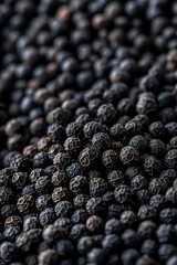 Wall Mural - Macro shot of the texture of ground black pepper highlighting the coarse dark specks with varied sizes 