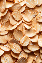 Wall Mural - Macro shot of the texture of rolled oats highlighting the flattened light brown grains with intricate layers 