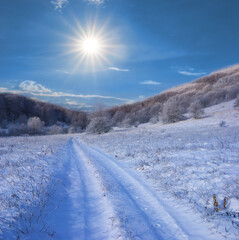 Wall Mural - snowbound mountain valley at winter sunny day