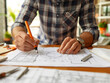 © wiparat - engineer working on blueprint at office desk