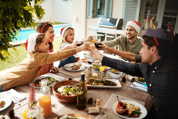 Wall Mural - Family, happy and cheers for Christmas, celebration and lunch at house with food, drinks and glass in backyard. Mom, dad and children for holiday, bonding and brunch with support, cheerful and fun