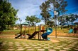 © Wirestock - Colorful playground with slides and climbing structures in a park on a sunny day. Brazil