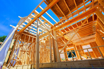 Canvas Print - In construction site, new home building framing with wooden trusses, post beams framework