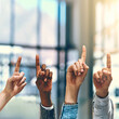 © JordaanExams/peopleimages.com - Business people, fingers and group for idea in office, feedback and emoji for brainstorming vote. Employees, team building and hand up for problem solving or solution, workshop and staff opinion