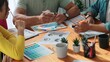 © InfiniteFlow - Top aerial view of business people working together to choosing color from color palette. Manager present idea by using tablet to marketing team while business man looking at logo graphic. Symposium.