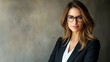 © CYBERPINK - A woman in a business suit and glasses is posing for a photo